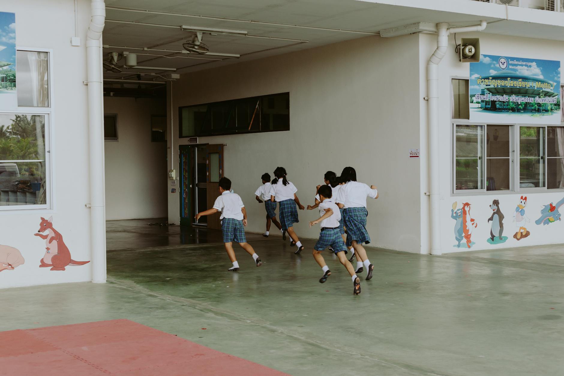 a group of students running inside the school