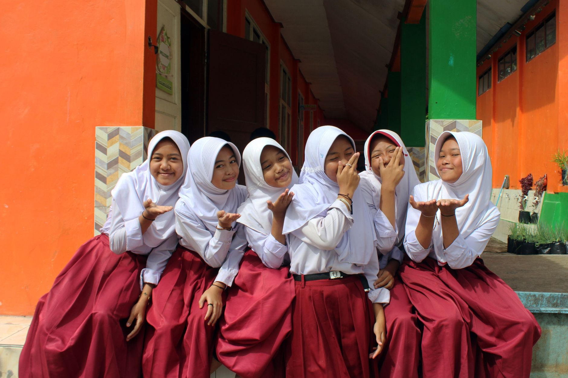 indonesian schoolgirls in uniform celebrating